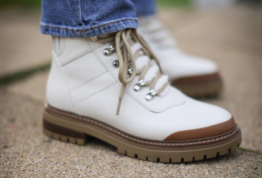 A close up of white hiking boots
